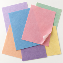 Load image into Gallery viewer, Illustrative close-up of assorted coloured edible wafer sheets with a gently lifted pink corner showing the pale reverse