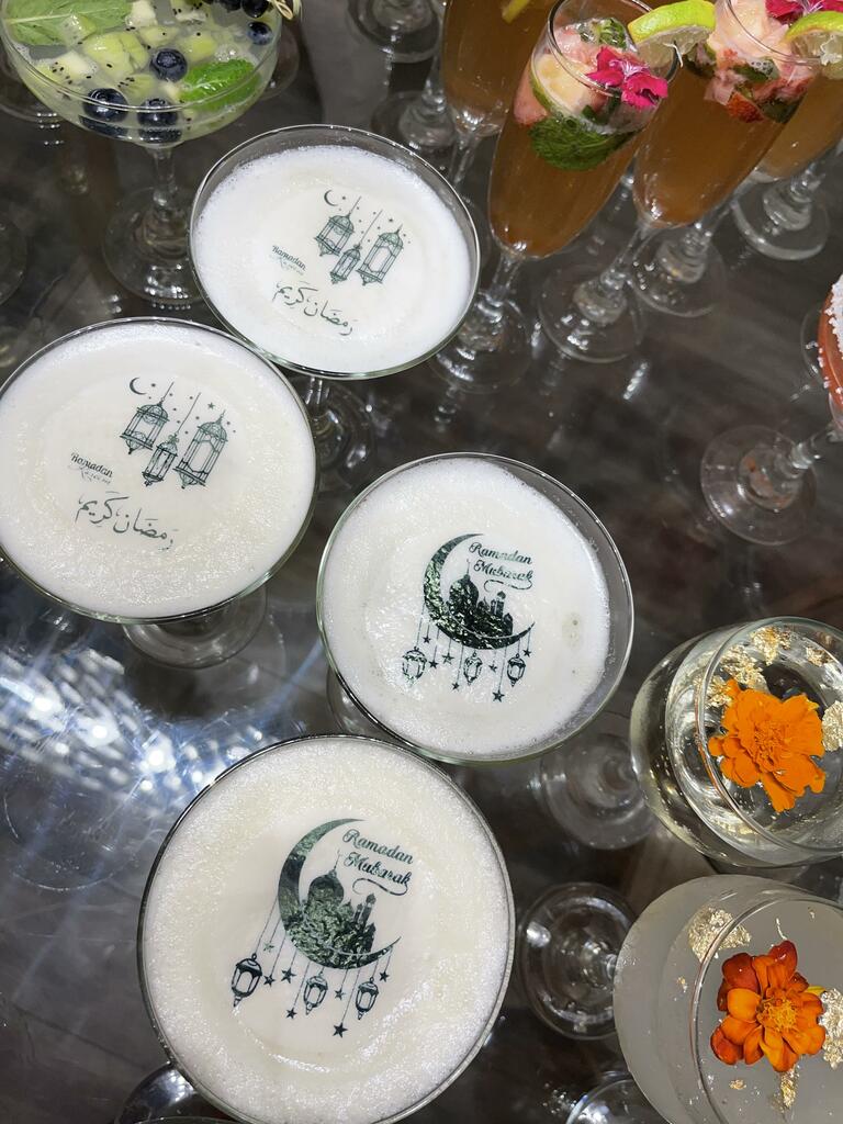 Ultra-thin edible icing toppers floating on colorful cocktails